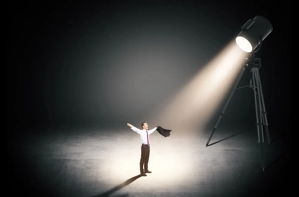 Businessman standing in a spotlight