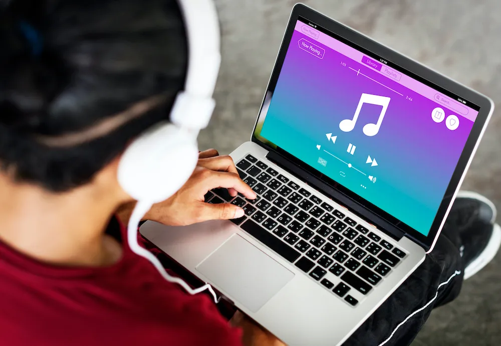 Listening to Chilli FM online on a laptop with headphones