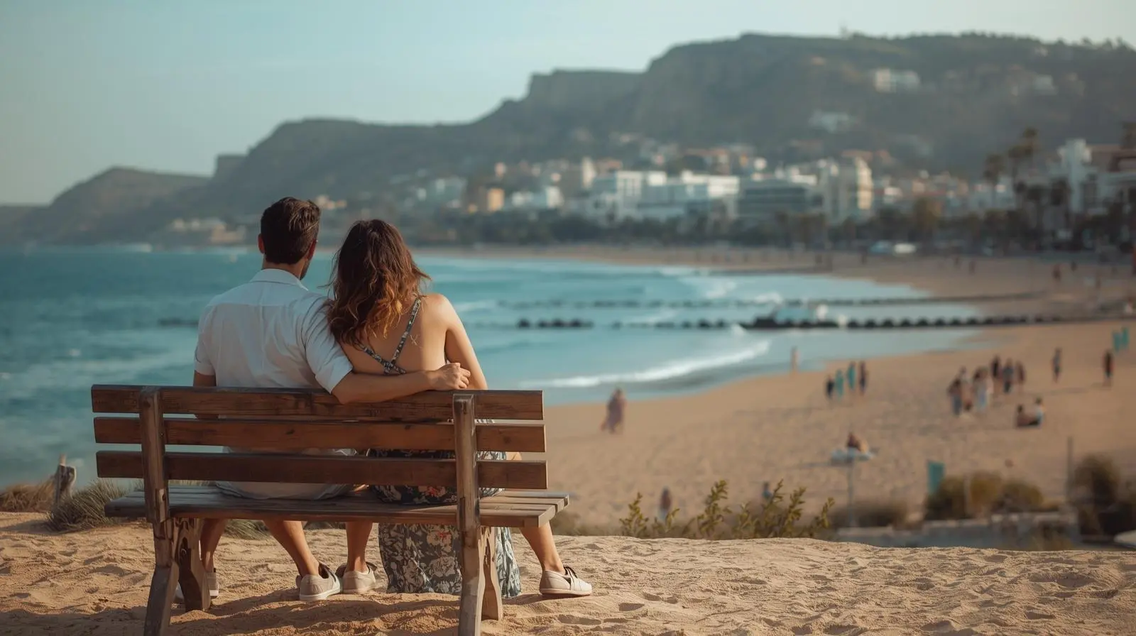 Couple on a bench looking out over a Costa del Sol beach